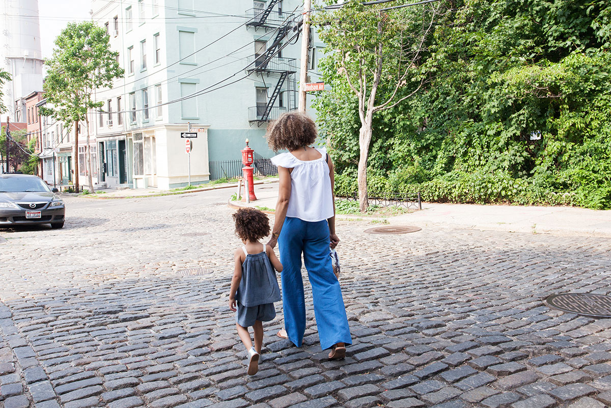 Mothers Walking On Cobblestone Street